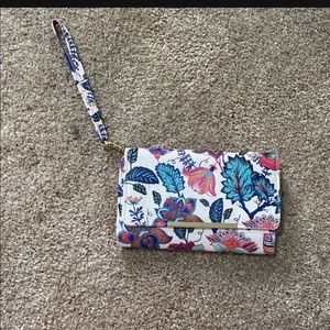 White and floral wristlet.